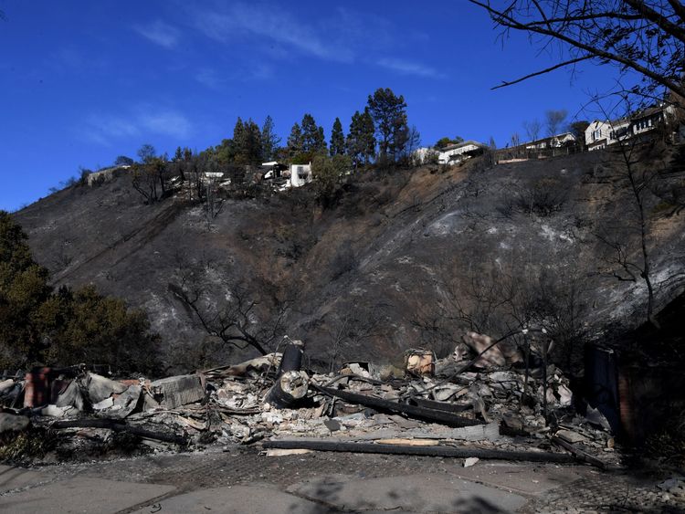 burnt out house is seen after the Skirball wildfire swept through the exclusive enclave of Bel Air, California on December 7, 2017. Local emergency officials warned of powerful winds on December 7 that will feed wildfires raging in Los Angeles, threatening multi-million dollar mansions with blazes that have already forced more than 200,000 people to flee. / AFP PHOTO / MARK RALSTON (Photo credit should read MARK RALSTON/AFP/Getty Images) Editorial subscription SML 4712 x 3296 px | 39.89 x 27.91 
