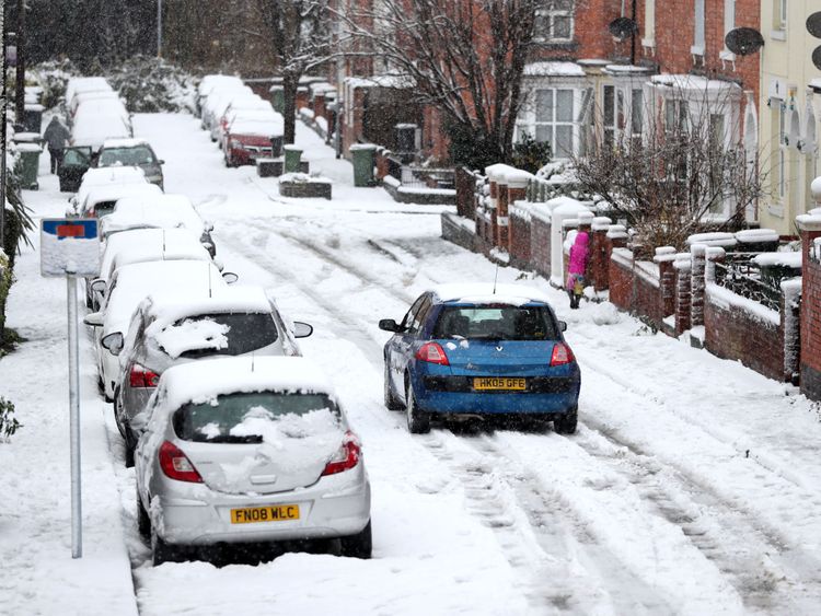Motorists brave the snow in Worcester, as heavy snowfall across parts of the UK is causing widespread disruption, closing roads and grounding flights at an airport.