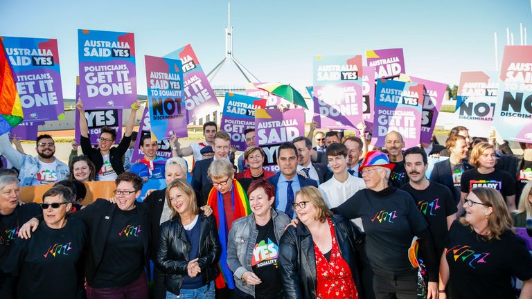 Campaigners gather outside Parliament House in Canberra for the vote