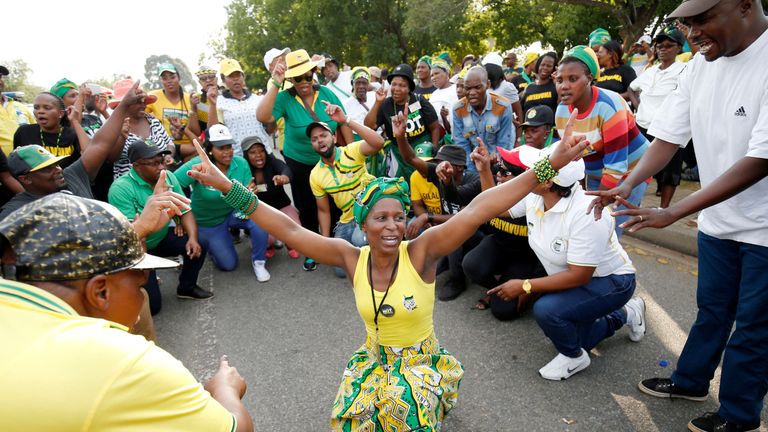 Supporters of Cyril Ramaphosa celebrate outside the ANC's party conference