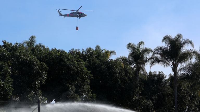 An US military helicopter from Camp Pendleton makes a water drop