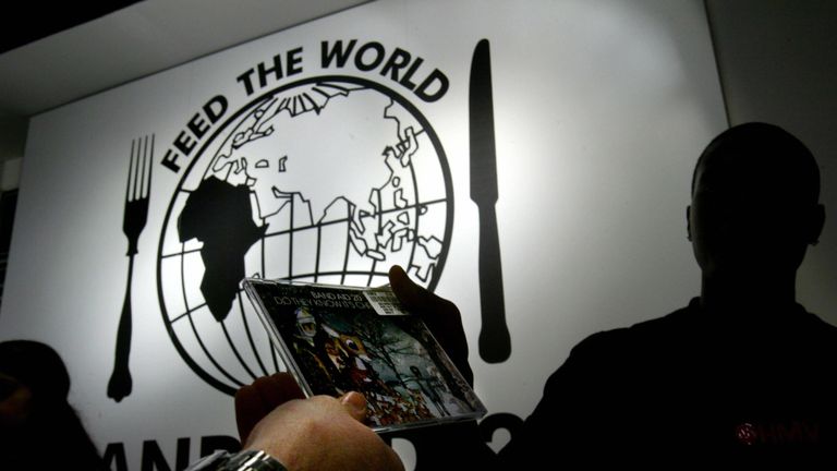 LONDON, UNITED KINGDOM: A cashier makes a sale of the new Band Aid 20 music single 'Do they know it's Christmas' on its release in a London music store 29 November, 2004. The single is remake of the Live Aid single of the same name, which was released 20 years ago. The proceeds of the album will go to famine relief. AFP PHOTO/CARL DE SOUZA (Photo credit should read CARL DE SOUZA/AFP/Getty Images)