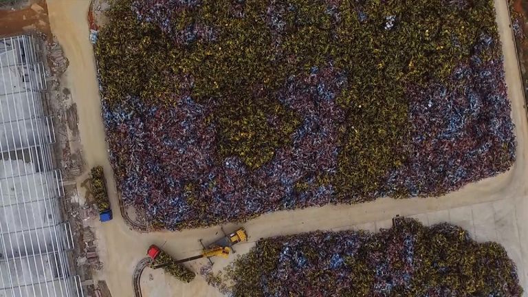 A crane is used to sort through the jumbled mass