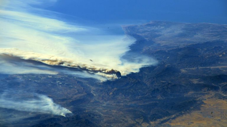 A photo taken from the International Space Station shows smoke rising from wildfires burning in Southern California. Pic: @AstroKomrade/NASA