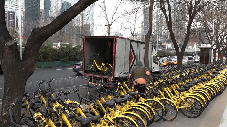 Rows of brightly coloured bicycles can be seen all over Beijing