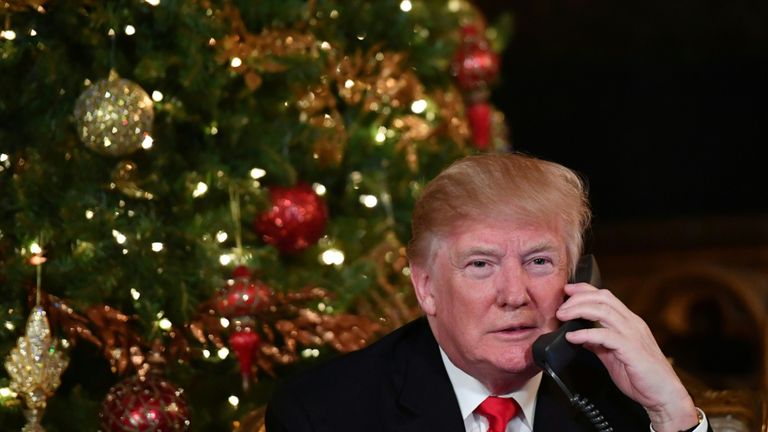 Donald Trump participates in NORAD Santa Tracker phone calls at the Mar-a-Lago resort in Palm Beach, Florida