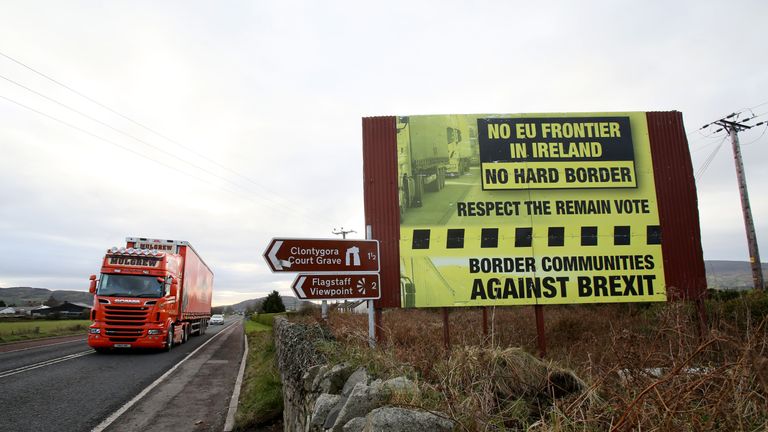 Traffic crosses the border into Northern Ireland from the Irish Republic alongside a Brexit Border poster on the Dublin road Co Armagh border