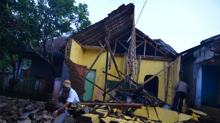 A man cleans up at a house in Sumelap Village. Pic: Antara Foto/Adeng Bustomi