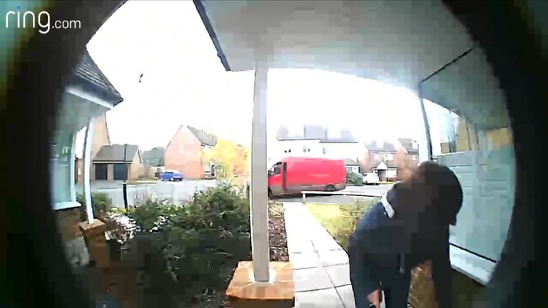 The woman is seen grabbing the parcel before jumping into a van