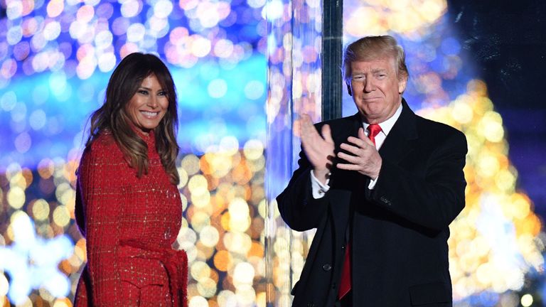 US President Donald Trump (R) gestures as First Lady Melania Trump smiles during the 95th annual National Christmas Tree Lighting ceremony at the Ellipse in President&#39;s Park near the White House in Washington, DC on November 30, 2017