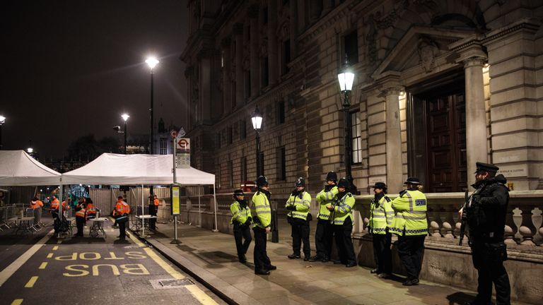 LONDON, ENGLAND - DECEMBER 31: Police and armed police officers standby next to a security checkpoint on Whitehall ahead of the New Year&#39;s Eve fireworks display on December 31, 2016 in London, England. Security has been stepped-up in London following the Berlin and Nice lorry attacks as thousands of people line the banks of the River of Thames tonight to watch the annual New Year&#39;s Eve fireworks display. (Photo by Jack Taylor/Getty Images)