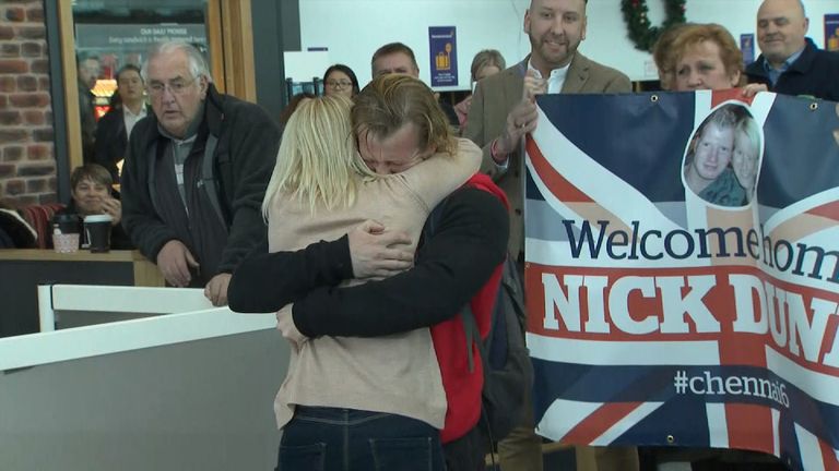 Nick Dunn at Newcastle airport hugging his wife