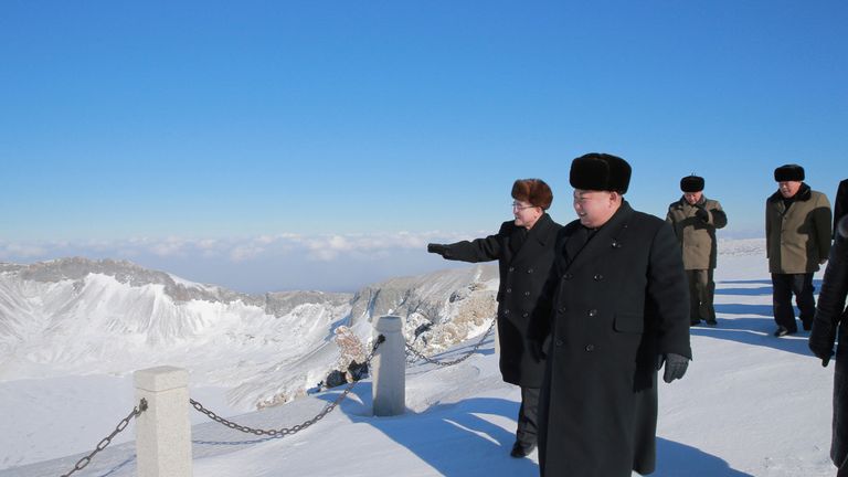 The leader wrapped up in the snowy conditions on Mount Paektu