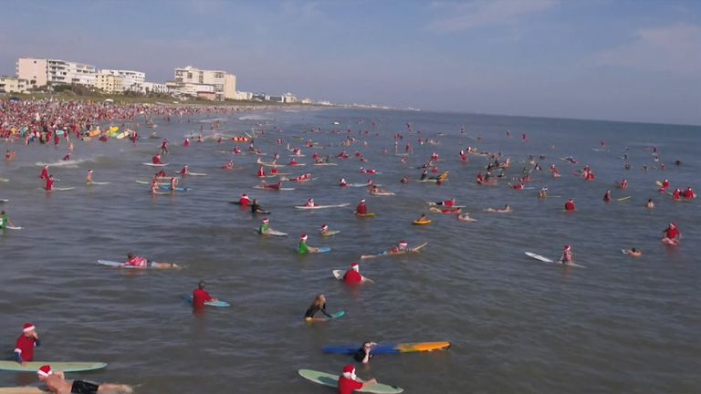 Hundreds of surfers dressed as Father Christmas took to the sea in Florida