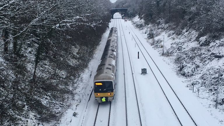 A train through the snow near Gerrards Cross in Buckinghamshire
