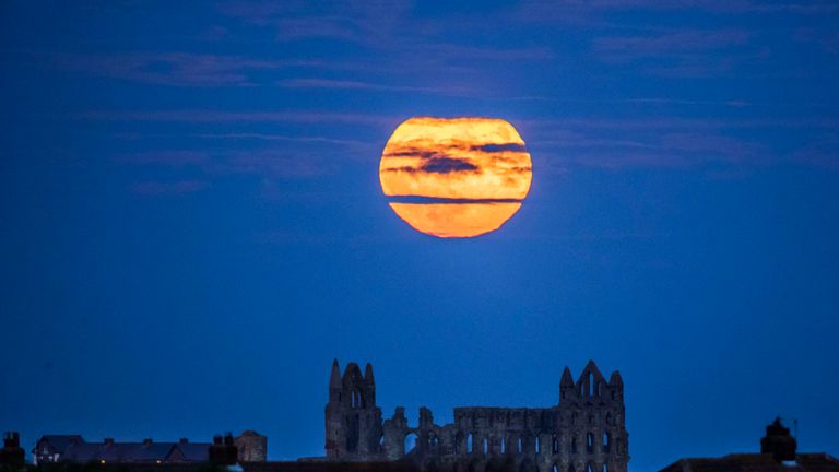 The &#39;supermoon&#39; rises above Whitby Abbey in Yorkshire