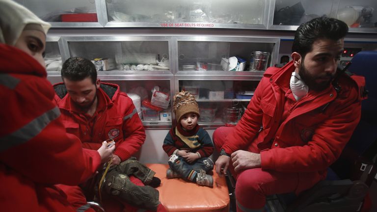 Syrian staff from the International Committee of the Red Cross take part in an evacuation operation in Douma in the eastern Ghouta