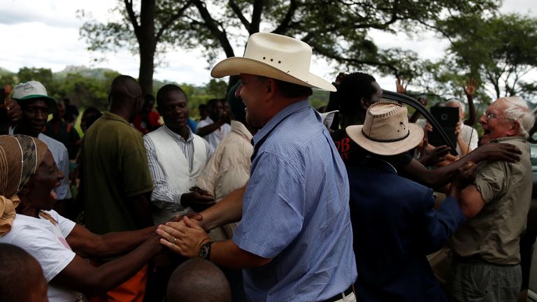 Robert are welcomed back by villagers and former workers