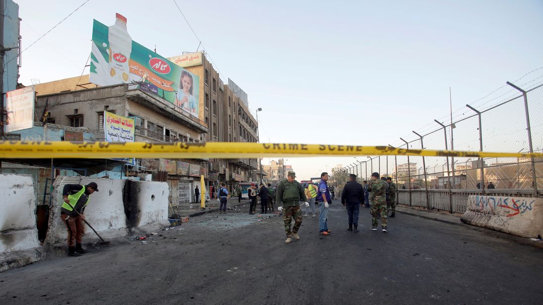 Officials close off the area following the attack in Baghdad