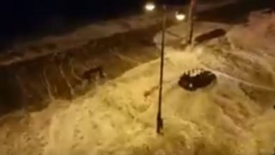A Mini is battered by huge waves as it drives along the seafront. Pic: @GalwayLatinQtr