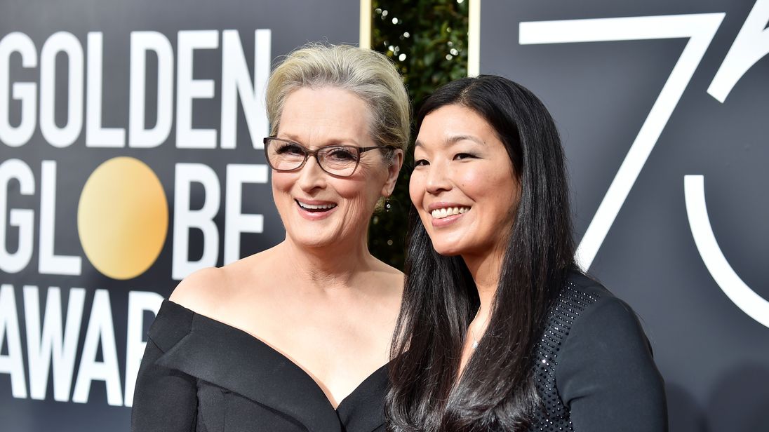 Meryl Street arrives at the Golden Globes with women's activist Ai-jen Poo