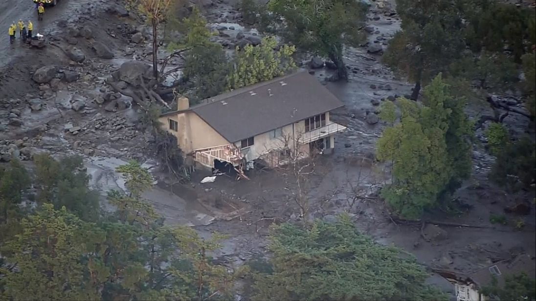 A house lies damaged following the mudslides in California