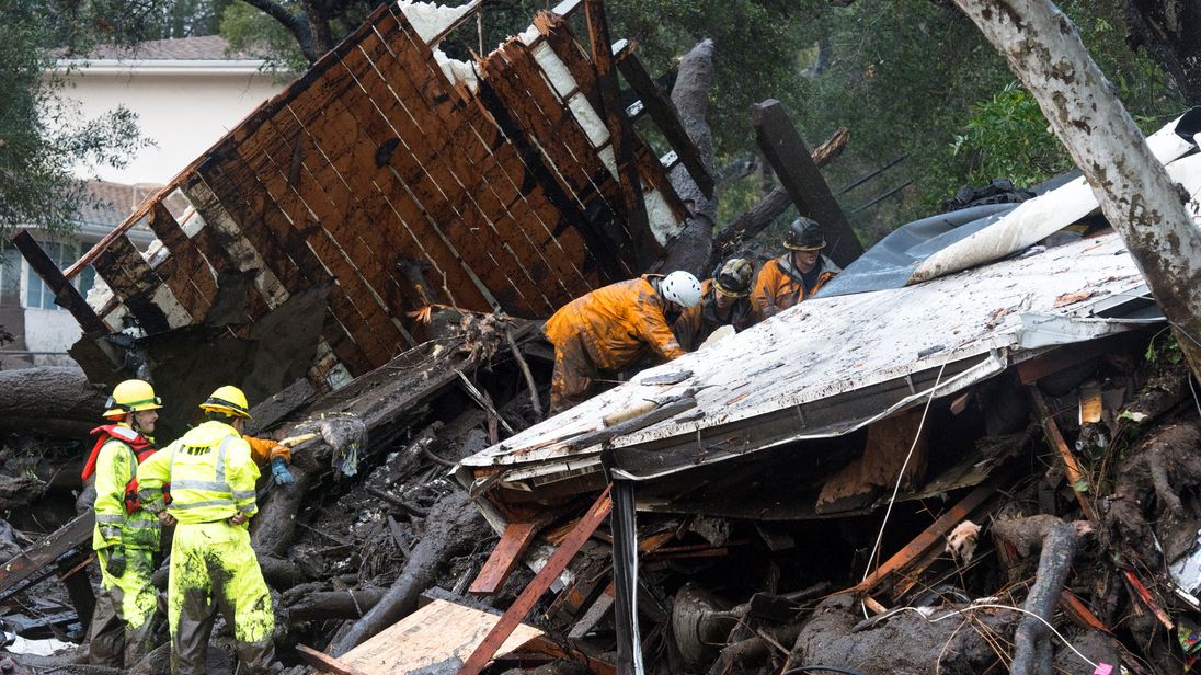 Emergency personnel prepare to rescue a trapped woman inside a collapsed house in Montecito, California, U.S. January 9, 2018. Pic: Santa Barbara News-Press