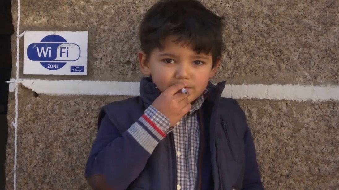 A boy smokes a cigarette during the festival