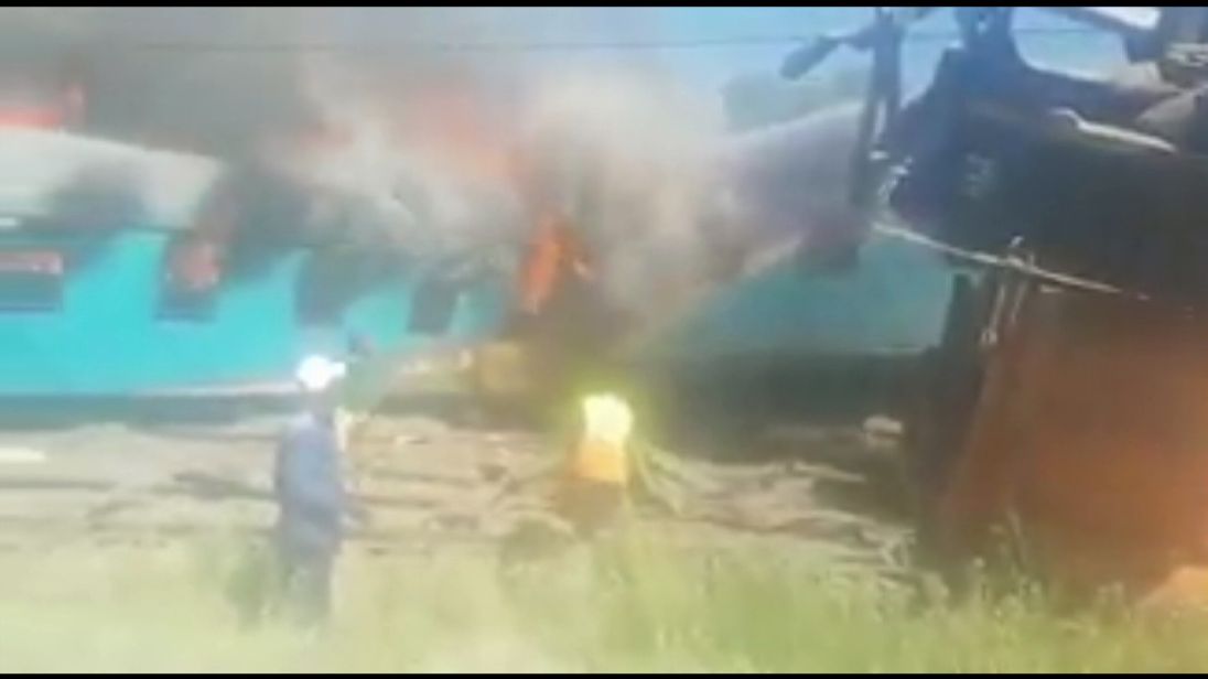 Firefighters battle the flames after the accident