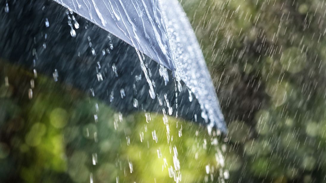 Heavy rain hitting an umbrella.