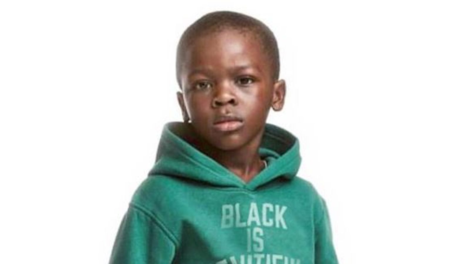 h and m ad. with black kid in green sweatshirt