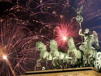 Fireworks explode over the Brandenburg Gate during New Year's festivities on January 1, 2018 in Berlin, Germany