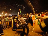 People dance during the New Year's celebrations on a beach in Mumbai, India, January 1, 2018