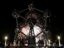 Fireworks light up the Atomium building, a metal structure built in the form of a crystal of iron, as part of new year celebrations in Brussels, Belgium January 1, 2018