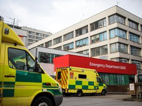 Ambulances sit outside the Accident and Emergency department of Guy&#39;s and St Thomas&#39; Hospital on January 3, 2018 in London, England. Hospitals in the UK have been advised to postpone all non-urgent operations until the end of January as the NHS struggles to cope with the surge in patients over the winter period