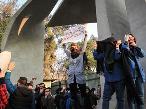 Iranian students protest at the University of Tehran during a demonstration driven by anger over economic problems, in the capital Tehran on December 30, 2017. Students protested in a third day of demonstrations sparked by anger over Iran&#39;s economic problems, videos on social media showed, but were outnumbered by counter-demonstrators. / AFP PHOTO / STR (Photo credit should read STR/AFP/Getty Images)

