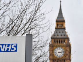 A NHS (National Health Service) sign is pictured outside St Thomas&#39; Hospital, near the Houses of Parliament, in central London on March 8, 2017. Britain&#39;s economy will grow by 2.0 percent this year, sharply up on a previous forecast of 1.4 percent, finance minister Philip Hammond said Wednesday in his budget statement. Hammond also announced a two billion pound increase in spending for social care, over the next three years, in an effort to tackle pressure on the NHS.