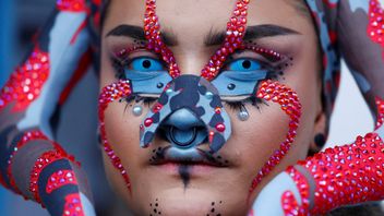 A person waits outside fashion show of designer Marina Hoermanseder during Berlin Fashion Week