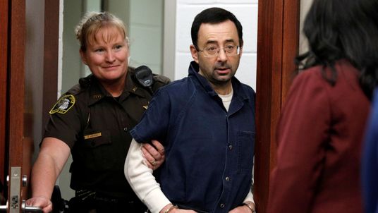 Larry Nassar is escorted into the courtroom during his sentencing hearing in Lansing, Michigan