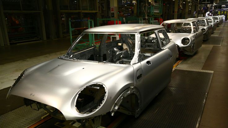Minis in the &#39;Body in white&#39; stage of manufacture pass on the production line at the BMW Mini car production plant in Oxford