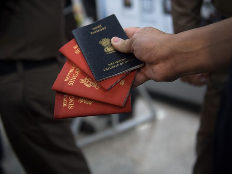 A Thai immigration officer displays some of the fake passports