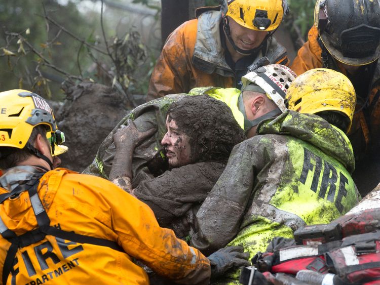 A woman is rescued from a collapsed house in Montecito. Pic: Santa Barbara News-Press