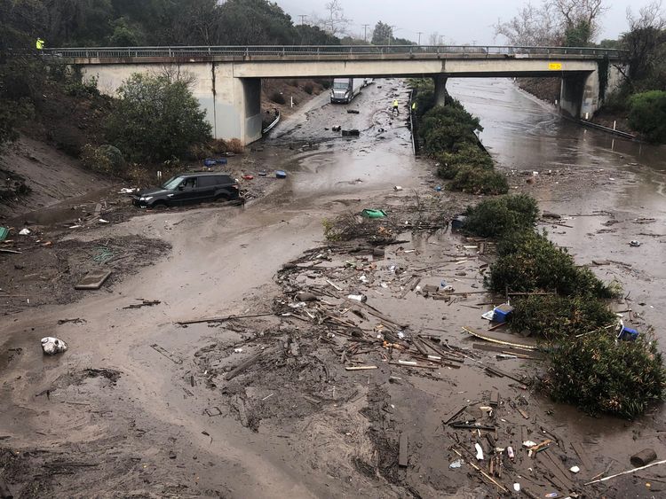 Abadoned cars stuck in flooded water on the freeway after a mudslide in Montecito, California