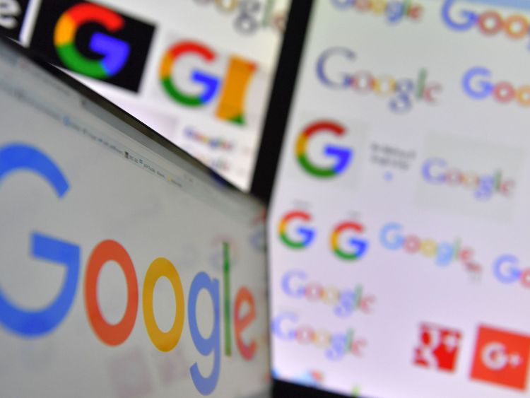 A picture taken on November 20, 2017 shows logos of US multinational technology company Google displayed on computers' screens