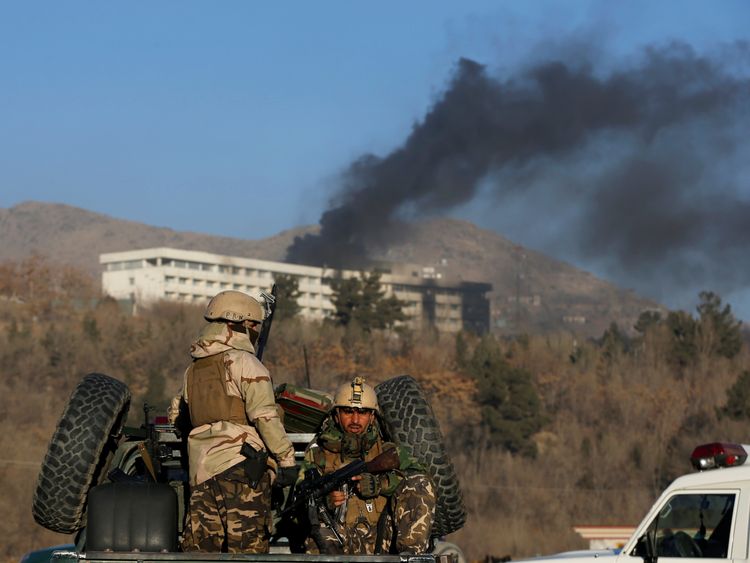 Afghan security forces keep watch as smoke rises from the Intercontinental Hotel in Kabul, Afghanistan January 21, 2018