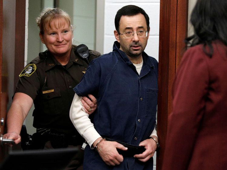Larry Nassar is escorted into the courtroom during his sentencing hearing in Lansing, Michigan
