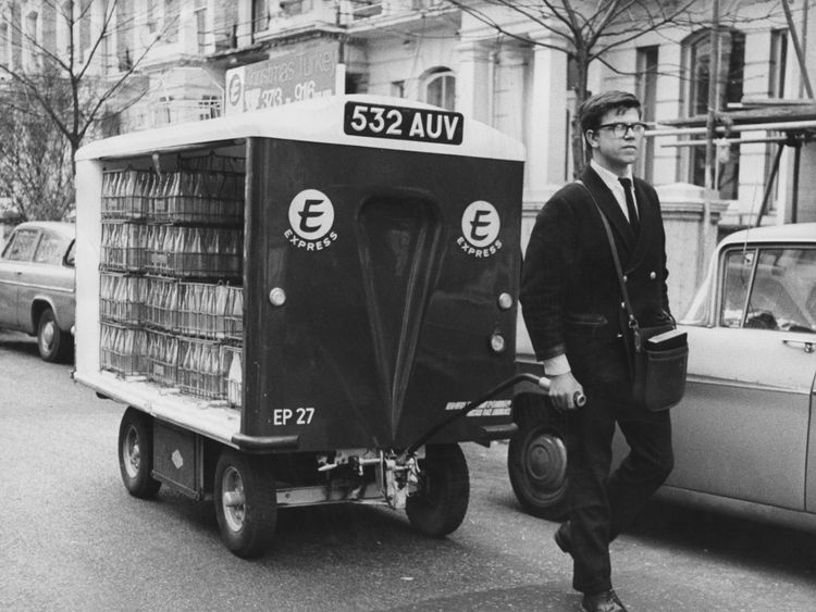 A milkman doing his rounds with a hand-pulled float in 1966