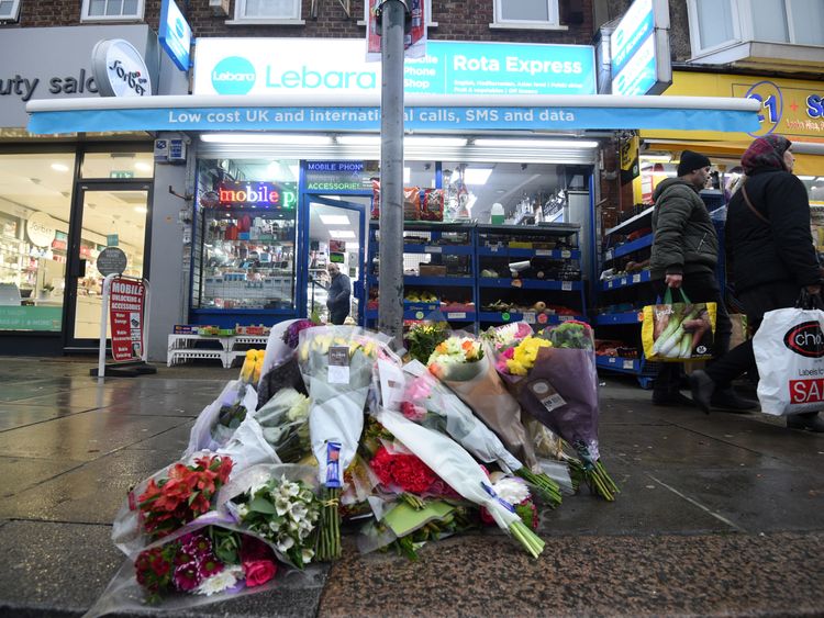 Tributes outside a shop on The Broadway in Mill Hill, north London, where a murder investigation has been launched after shop worker Vijay Patel was fatally attacked in a row over cigarette papers.