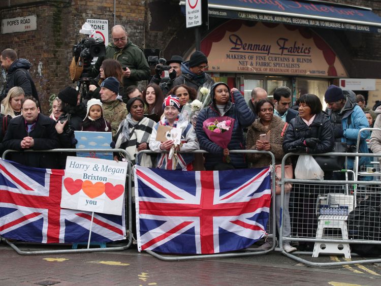 People wait for the arrival of Prince Harry and Meghan Markleat Reprezent FM, in Brixton, south London 