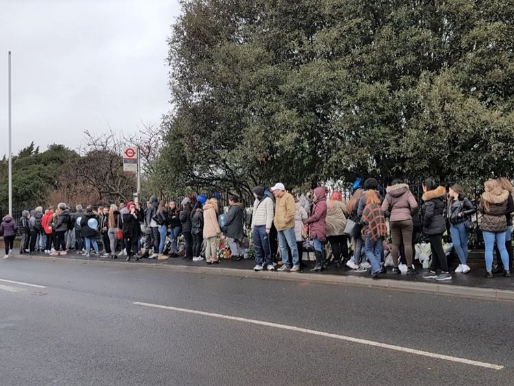 People stand at the scene of the crash